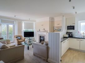 A living room with a sofa and armchair at 2 St Michaels House in Lyme Regis