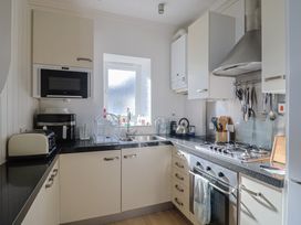 A kitchen with stove and appliances at 2 St Michaels House in Lyme Regis