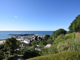 A view of the sea and harbor from a garden at 2 St Michaels House Lyme Regis