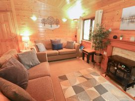 A living room with a sofa and fireplace at Derwent Lodge in Keswick