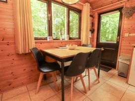 A dining room with a table and chairs at Derwent Lodge in Keswick