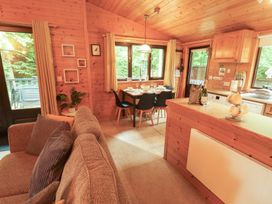 A kitchen with a dining table and chairs at Derwent Lodge in Keswick