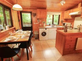 A kitchen with a table set for dinner at Derwent Lodge in Keswick