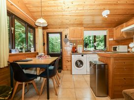 A kitchen with a table and chairs at Derwent Lodge in Keswick