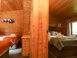 A bedroom with two beds and a window at Derwent Lodge in Keswick