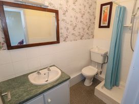 A bathroom with a sink, toilet, and shower at Sea View House in Tully, County Galway