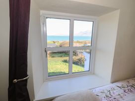A window with a view of the sea and landscape at Sea View House in Tully, County Galway