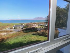A view from a window showing the sea and mountains at Sea View House in Tully, County Galway