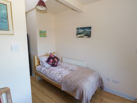 A bedroom with a bed and wall art at Sea View House in Tully, County Galway