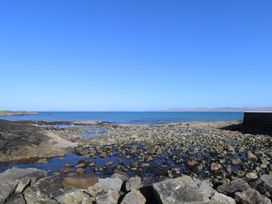 A coastal scene with rocks and water at Sea View House in Tully, County Galway