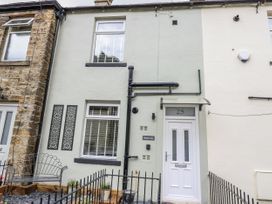 A house exterior with front door and decorative panel at Millside View