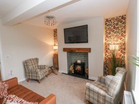 A living room with a television and fireplace at Millside View 