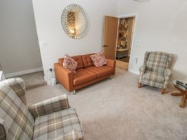 A living room with a sofa and armchairs at Millside View