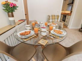 A dining room table set with croissants and juice at Millside View 