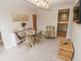 A dining room with a table set for meals at Millside View