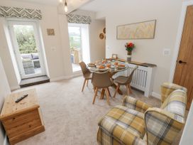 A dining room with a table set for a meal at Millside View in 