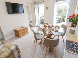 A dining area with a table and chairs at Millside View