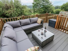 An outdoor living area with a sofa and table at Millside View