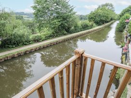A view of a canal and greenery from a balcony at Millside View