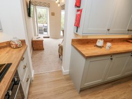 A kitchen with cabinets and countertop at Millside View
