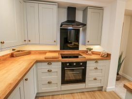 A kitchen with cabinets and appliances at Millside View