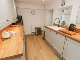 A kitchen with cabinets, sink, and countertop at Millside View