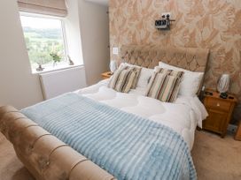 A bedroom with a bed and nightstands at Millside View