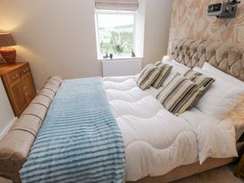 A bedroom with a bed and window at Millside View in 