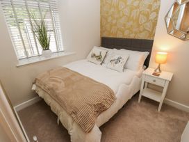 A bedroom with a bed and bedside table at Millside View 