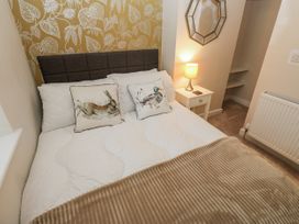 A bedroom with a bed and pillows at Millside View 