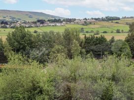 A view of hills and fields with trees at Millside View