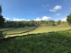 A field with sheep and a building at Millside View in Kildwick