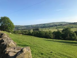 A view of hills and sheep in a field at Millside View in Kildwick