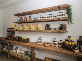 A kitchen with shelves displaying various jars and packages at Canadian Cabin No 39 in Keswick