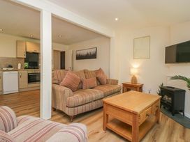 A living room with a sofa and coffee table at Chestnut Timber Lodge in Keswick