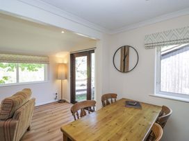 A dining room with a table and chairs at Chestnut Timber Lodge in Keswick