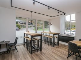 A cafe with high tables and stools at Dogwood Timber Lodge in Keswick