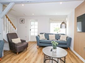 A living room with a sofa and armchair at Riverside Cottage No 4 in Keswick