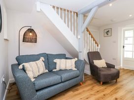 A living room with a sofa and armchair at Riverside Cottage No 4 in Keswick