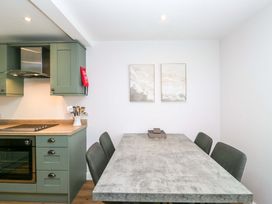 A kitchen with a table and chairs at Riverside Cottage No 4 in Keswick