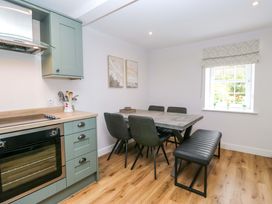 A dining room with a table and chairs at Riverside Cottage No 4 Keswick