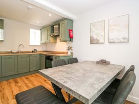 A kitchen with an oven and sink at Riverside Cottage No 4 in Keswick