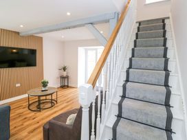 A living room with a sofa and table at Riverside Cottage No 4 in Keswick