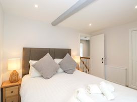 A bedroom with a bed and lamp at Riverside Cottage No 4 in Keswick