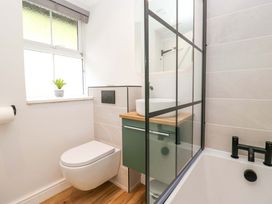 A bathroom with a shower and sink at Riverside Cottage No 4, Keswick