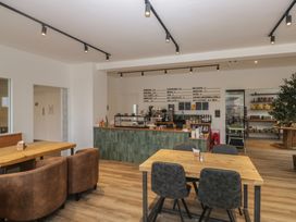 A cafe with tables and a coffee counter at Pod No 6 in Keswick