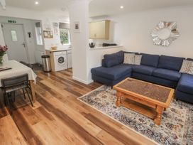 A living room with a sofa and coffee table at Chellowdene Cottage in Falmouth