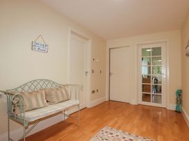 A hallway with a bench and doors at Pen-Y-Les in Wadebridge