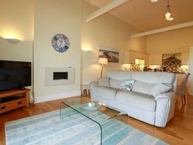 A living room with a sofa and television at Pen-Y-Les in Wadebridge
