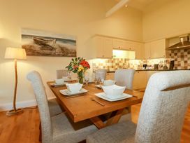 A dining room with a table set for dinner at Pen-Y-Les Wadebridge